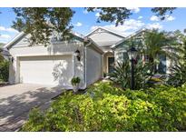 Charming single-Gathering home featuring lush landscaping and an attached two-car garage at 4402 Natures Reach Ter, Parrish, FL 34219