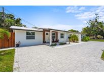 Charming one-story home with a paved driveway, manicured lawn, and a welcoming front entrance at 515 N Osprey Ave, Sarasota, FL 34236