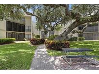 Beautiful condo complex with brick pavers and lush landscaping at 6157 Midnight Pass Rd # E73, Sarasota, FL 34242