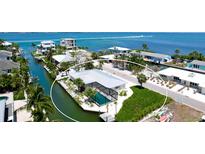 Waterfront home with private pool and dock offering direct access to the Gulf of Mexico at 791 Saint Judes Dr N, Longboat Key, FL 34228