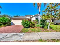 Charming single-story home with a brick driveway and well-maintained landscaping at 9022 Coachman Dr, Venice, FL 34293