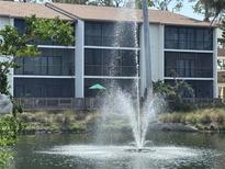 Lovely view of the condo exterior overlooking the water feature at 1170 Bird Bay Way # 206, Venice, FL 34285