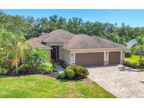 Charming single-story home featuring a three-car garage, manicured landscaping and a brick paver driveway at 15208 21St E Ave, Bradenton, FL 34212