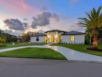 Beautiful single-story home with landscaped front yard and a modern circular driveway at 180 Lookout Point Dr, Osprey, FL 34229