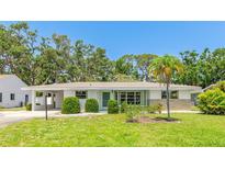 Charming single-story home with well-maintained lawn and mature trees at 2110 Craft Ln, Sarasota, FL 34239