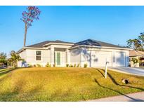 Charming single-story home with a three-car garage and a well-manicured lawn at 2258 Margaret Ln, North Port, FL 34286