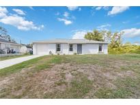 Charming one-story home with a well-manicured lawn, an attached garage, and inviting curb appeal at 2341 Sheila Ln, North Port, FL 34286