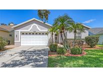 Charming single-story home with lush landscaping, a manicured lawn, and a two-car garage at 4208 Balmoral Way, Sarasota, FL 34238