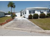 Cozy single-story home featuring a palm tree and driveway in a well-maintained community at 5118 Oakland Hills Ave, Sarasota, FL 34234