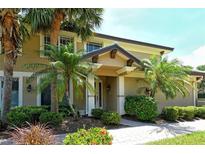Charming home showcasing a well-manicured lawn and tropical landscaping for curb appeal at 6552 Moorings Point Cir # 201, Lakewood Ranch, FL 34202