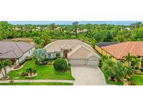Charming single-story home with a well-manicured lawn and a three-car garage in a lush neighborhood at 7126 Southgate Ct, Sarasota, FL 34243