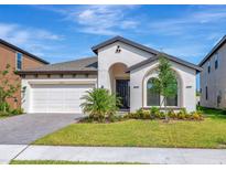 Charming single-story home with a well-manicured lawn and an attached two-car garage at 12613 Oak Hill Way, Parrish, FL 34219