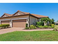 Charming home featuring a tile roof, two-car garage, well-maintained landscaping and lovely curb appeal at 15707 Sacile Ln, Bradenton, FL 34211
