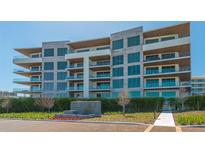 Luxury condo building with multiple floors, large windows, and private balconies with glass railings at 1591 Gulf Of Mexico Dr # 511, Longboat Key, FL 34228