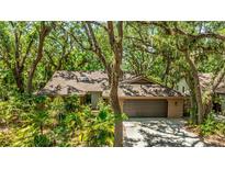 Charming single-story home with a two-car garage and lush landscaping at 2061 Misty Sunrise Trl, Sarasota, FL 34240