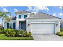 Beautiful single Gathering home with a neutral exterior and inviting curb appeal at 2578 Wild Cherry Path, Sarasota, FL 34240