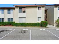 Inviting condo exterior with manicured hedges and designated guest parking spaces at 2704 Hidden Lake Blvd # C, Sarasota, FL 34237