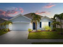 Charming single-story home featuring a two-car garage, well-manicured lawn and tropical landscaping at 2721 Greenleaf Ter, Parrish, FL 34219