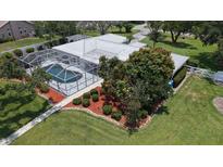 Aerial view of home showcasing screened pool, landscaping and metal roof at 3764 Oak Grove Dr, Sarasota, FL 34243