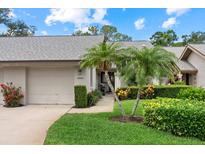 Charming single story home featuring an attached garage, lush landscaping, and a well-manicured lawn at 4505 Kingsmere # 2, Sarasota, FL 34235