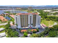 A high-rise building overlooking a beautiful bay with lush greenery and clear blue skies at 501 Haben Blvd # 506, Palmetto, FL 34221
