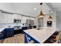 Modern kitchen boasts two-tone cabinets, stainless steel appliances, and a large island with seating at 501 Haben Blvd # 506, Palmetto, FL 34221