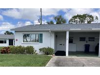 Charming home with green shutters, a covered carport, and well-maintained landscaping at 6110 Coral Way, Bradenton, FL 34207