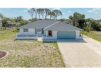 Charming single-story home featuring a well-maintained yard and an attached two-car garage at 645 Liberty St, Englewood, FL 34223