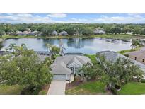 Beautiful single-Gathering home with mature trees, well-manicured lawn and lake front view at 6552 Meandering Way, Lakewood Ranch, FL 34202