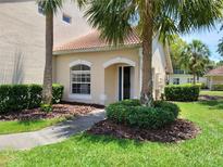 Charming home exterior with a well-manicured lawn and lush palm trees at 7273 Cedar Hollow Cir # 102, Bradenton, FL 34203