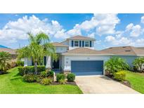 Charming two-story home boasts a well-manicured lawn, lush landscaping, and a two-car garage at 7379 47Th Avenue E Cir, Bradenton, FL 34203
