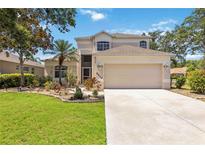 Charming two-story home with a well-maintained lawn, beautiful landscaping, and a two-car garage at 8222 Haven Harbour Way, Bradenton, FL 34212