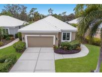 Aerial view of a single-story home with a well-manicured lawn and driveway at 8706 52Nd E Dr, Bradenton, FL 34211