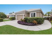 Charming single-story home with a well-manicured lawn and lush landscaping at 8706 52Nd E Dr, Bradenton, FL 34211