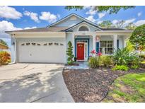 Charming single-Gathering home with a well-maintained lawn, an attached two-car garage, and a vibrant red front door at 11208 Blue Sage Pl, Lakewood Ranch, FL 34202