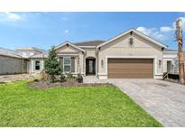 Beautiful single-Gathering home featuring a well-manicured lawn, neutral colored paint, and a two car garage at 11427 Viani Ter, Palmetto, FL 34221