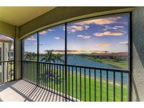 A screened balcony with stunning views of the lake and picturesque sunset at 121 Porta Vecchio Bnd # 201, Nokomis, FL 34275