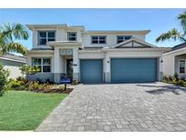 Beautiful two-story home featuring a well-manicured lawn and a two-car garage at 17723 Palmiste Dr, Bradenton, FL 34202