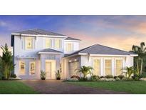 Charming two-story home with a well-maintained lawn, landscaped with shrubs and beautiful twilight skies at 17911 Palmiste Dr, Bradenton, FL 34202