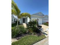 Charming single-story home with well-maintained landscaping and a welcoming front entrance at 24779 Buckingham Way, Port Charlotte, FL 33980