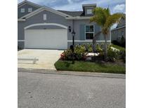 Charming single-Gathering home featuring a two-car garage and well-maintained landscaping at 24831 Buckingham Way, Port Charlotte, FL 33980
