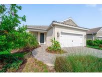 Charming single-story home with a well-manicured lawn, paver walkway and a two-car garage at 2625 Star Apple Way, Sarasota, FL 34240