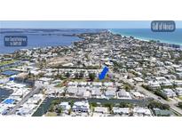 Stunning aerial view of a waterfront community with canal access and Gulf of Mexico views at 407 63Rd St, Holmes Beach, FL 34217
