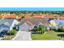 Charming single-story home with a well-maintained lawn, mature landscaping, and an attached two-car garage at 4585 Dover Street E Cir, Bradenton, FL 34203