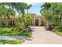 Elegant home featuring manicured landscaping, a brick driveway and double door entry at 6808 Belmont Ct, Lakewood Ranch, FL 34202