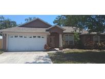 Charming single-story home featuring a two-car garage and a well-maintained front lawn at 7004 Mauna Loa Blvd, Sarasota, FL 34241