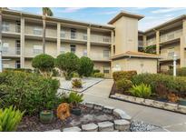 Well-maintained condominium complex featuring lush landscaping, sidewalks, and multiple stories with balconies at 9630 Club South Cir # 6303, Sarasota, FL 34238