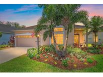 Charming single-story home featuring a well-manicured front yard, inviting entrance, and attached garage at 12322 Tall Pines Way, Lakewood Ranch, FL 34202