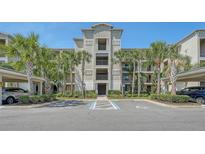 Three story condominium building in tropical setting with covered parking and handicap parking spaces at 17704 Gawthrop Dr # 303, Lakewood Ranch, FL 34211