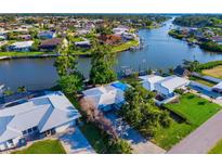 Waterfront homes feature boat docks along a tranquil canal, showcasing an idyllic coastal living community at 1921 Fairview Dr, Englewood, FL 34223